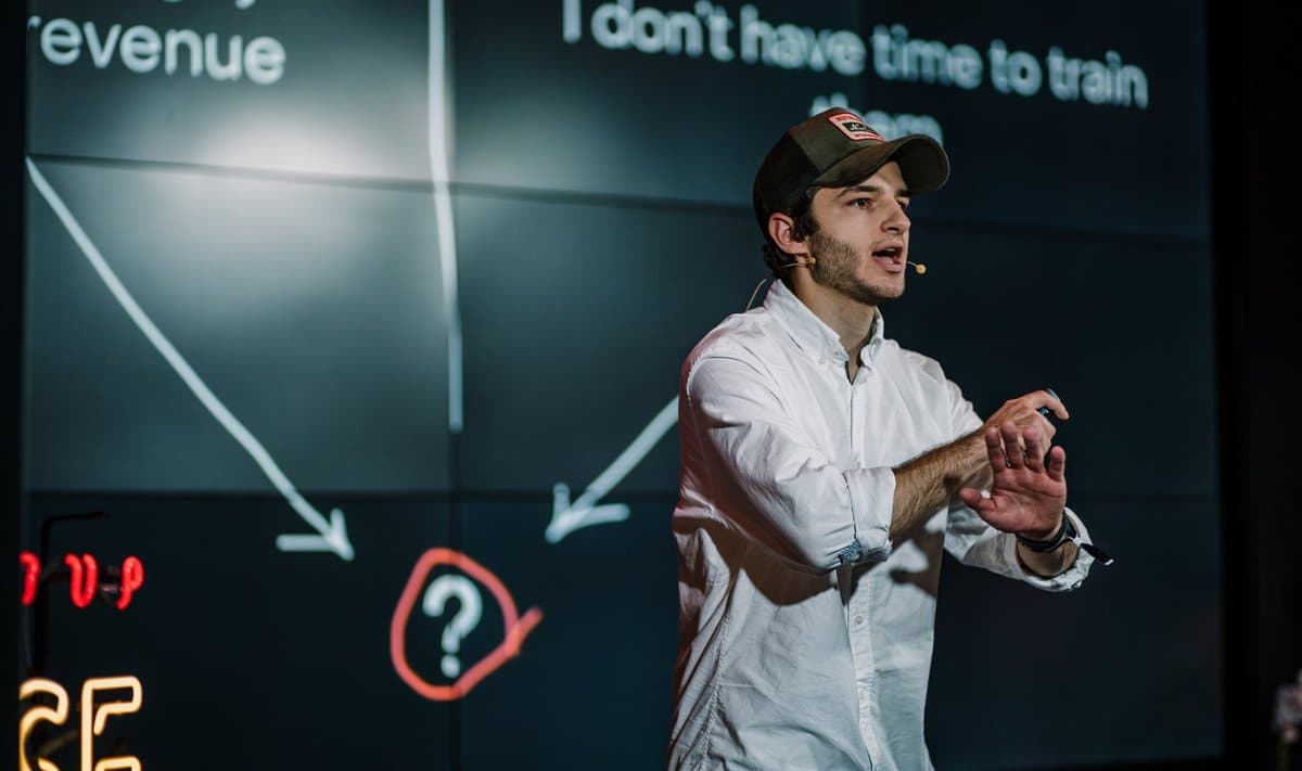Oleg speaking on stage at a sales event